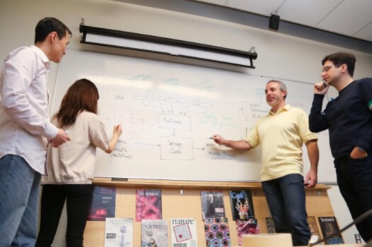 CAPTION Professor Brendan Frey (centre-right) and colleagues at the University of Toronto Faculty of Applied Science & Engineering. CREDIT Roberta Baker/ U of T Engineering