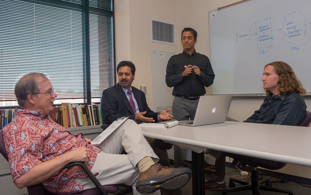 Rice University computer scientists (from left) Keith Cooper, Vivek Sarkar, Swarat Chaudhuri and Chris Jermaine discuss the PLINY project. CREDIT: Jeff Fitlow/Rice University