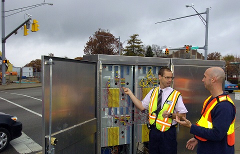 Darcy Bullock, from left, a Purdue professor of civil engineering, and former postdoctoral research associate Edward J. Smaglik, discuss information provided by detection equipment at an instrumented intersection. The research aims to improve the safety and efficiency of traffic flow. 