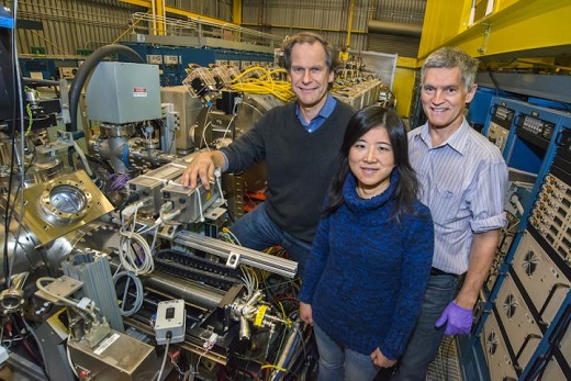 CAPTION From left are, Berkeley Lab scientists Thomas Schenkel, Qing Ji and Peter Seidl at the NDCX-II (Neutralized Drift Compression Experiment II), which produces powerful ion beams. Researchers are exploring how to use NDCX-II to process exotic materials, like the silicon-bismuth sample used in a recent microwave-based experiment relevant to quantum computing. CREDIT Credit: Roy Kaltschmidt/Berkeley Lab