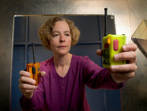 Measurements to help safeguard first responders: NIST engineer Kate Remley holds two Personal Alert Safety System (PASS) devices with wireless alarm capability. Copyright: Paul Trantow/Altitude Arts