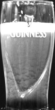 Bubble texture of Guinness beer in a pint glass, featuring the creamy taste of tiny bubbles and fascinating texture motion.