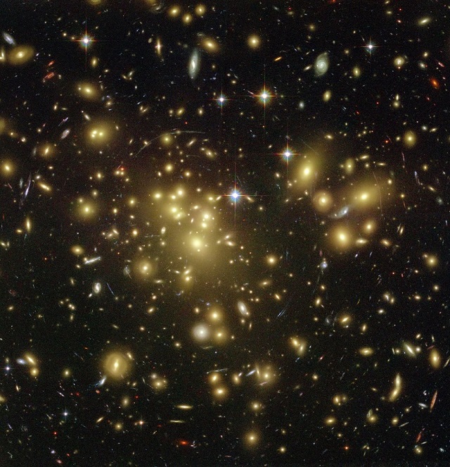 Image showing the galaxy cluster Abell1689. The novel deep learning tool Deep-CEE has been developed to speed up the process of finding galaxy clusters such as this one, and takes inspiration in its approach from the pioneer of galaxy cluster finding, George Abell, who manually searched thousands of photographic plates in the 1950s.