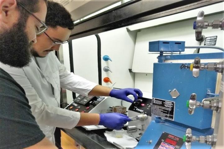 Reinaldo Dos Santos (left) and Vitor Prado Correia, seniors in FAU's Department of Ocean and Mechanical Engineering, extruding fiber in the laboratory under the direction of Hassan Mahfuz, Ph.D., principal investigator, and Oren Masory, Ph.D., co-principal investigator of the body armor project.