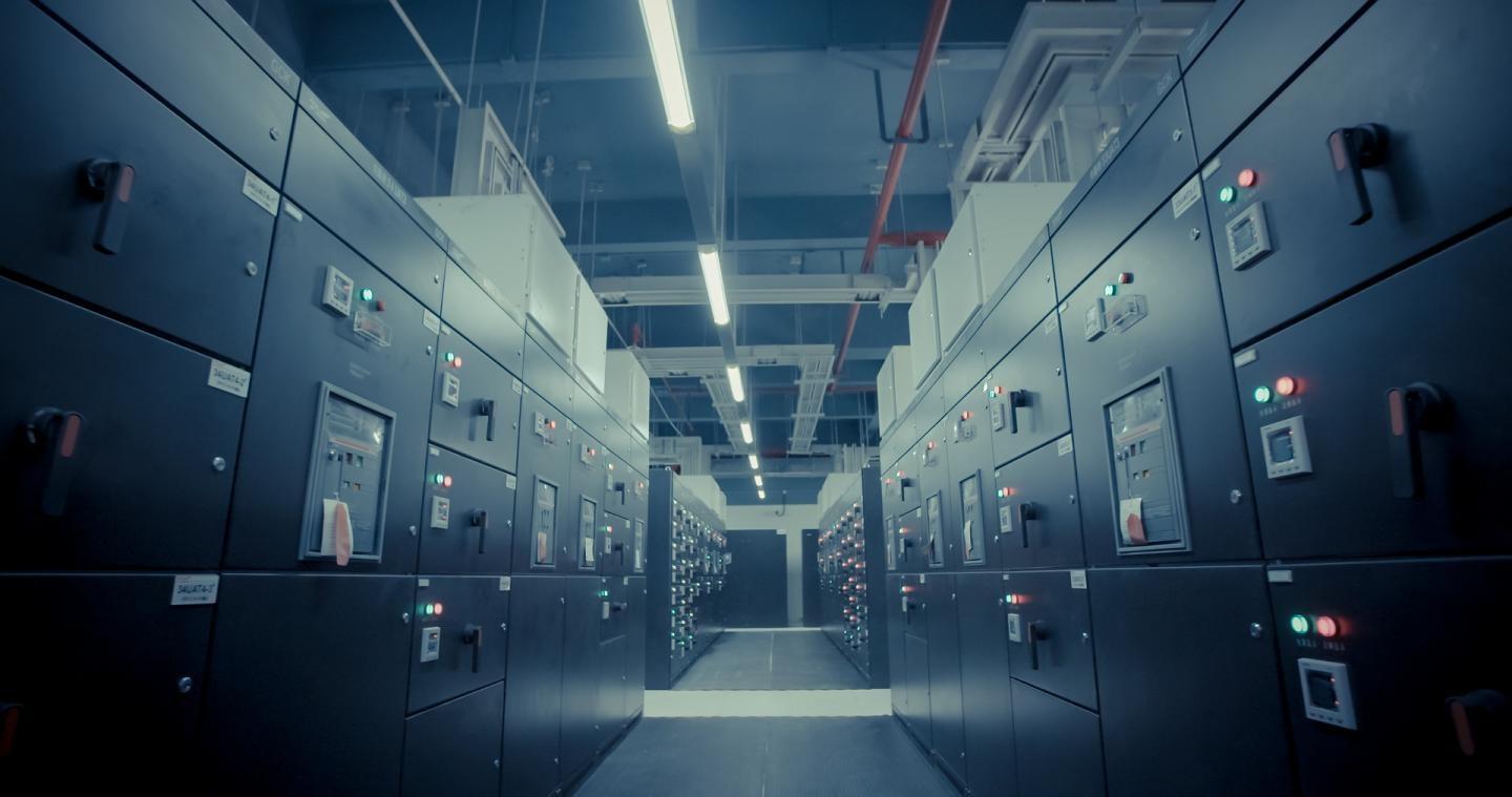 Computing consumes 8% of global electricity, largely in massive, factory-sized data centres. This already-unsustainable energy load that is doubling every decade.