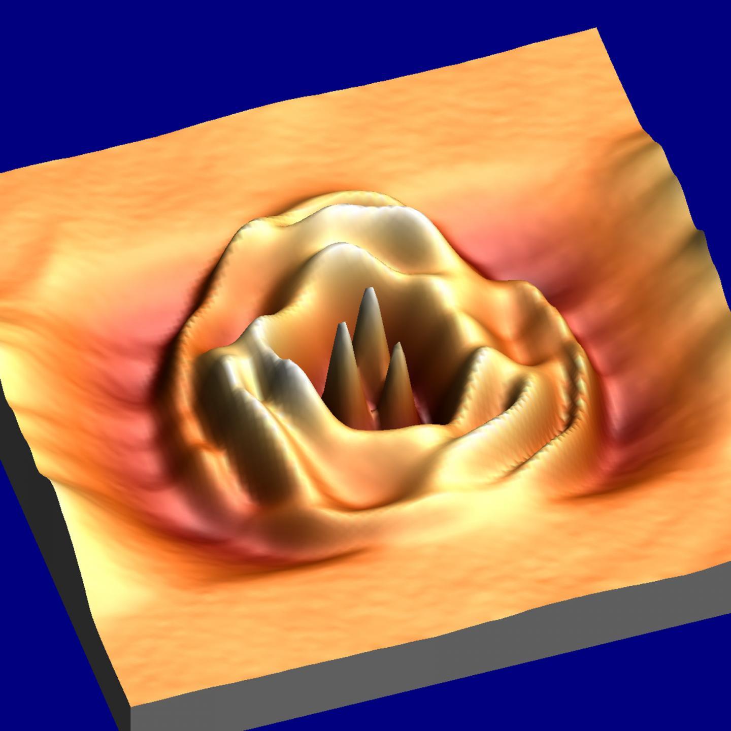 CAPTION Visualization of quantum dots in bilayer graphene using scanning tunneling microscopy and spectroscopy reveals a three-fold symmetry. In this three-dimensional image, the peaks represent sites of high amplitude in the waveform of the trapped electrons.  CREDIT Zhehao Ge, Frederic Joucken, and Jairo Velasco Jr.