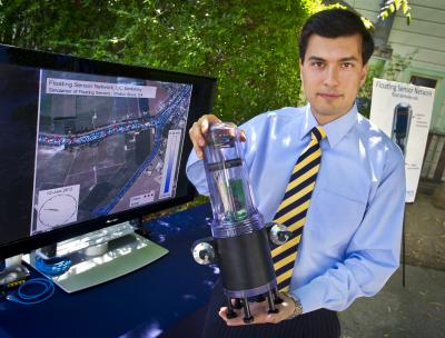 Alexandre Bayen, UC Berkeley associate professor in the College of Engineering, holds a floating robot. Fleets of robots can be used to advance our understanding of water conditions.  Credit: Roy Kaltschmidt, Lawrence Berkeley National Laboratory