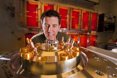 Sandia researcher Ryan McBride pays close attention to the tiny central beryllium liner to be imploded by the powerful magnetic field generated by Sandia’s Z machine. The larger cylinders forming a circle on the exterior of the base plate measure Z’s load current by picking up the generated magnetic field.  Credit: Courtesy, Sandia National Laboratories (Photo by Randy Montoya)