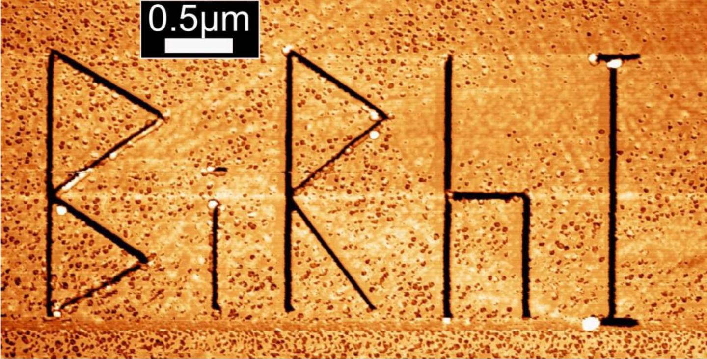 Microscopic image of the topological insulator Bismuth-Rhodium-Iodine (Bi14Rh3I9). The engraved letters BiRhI act as artificially introduced steps at the crystal surface.   Credit  M. Morgenstern, RWTH Aachen