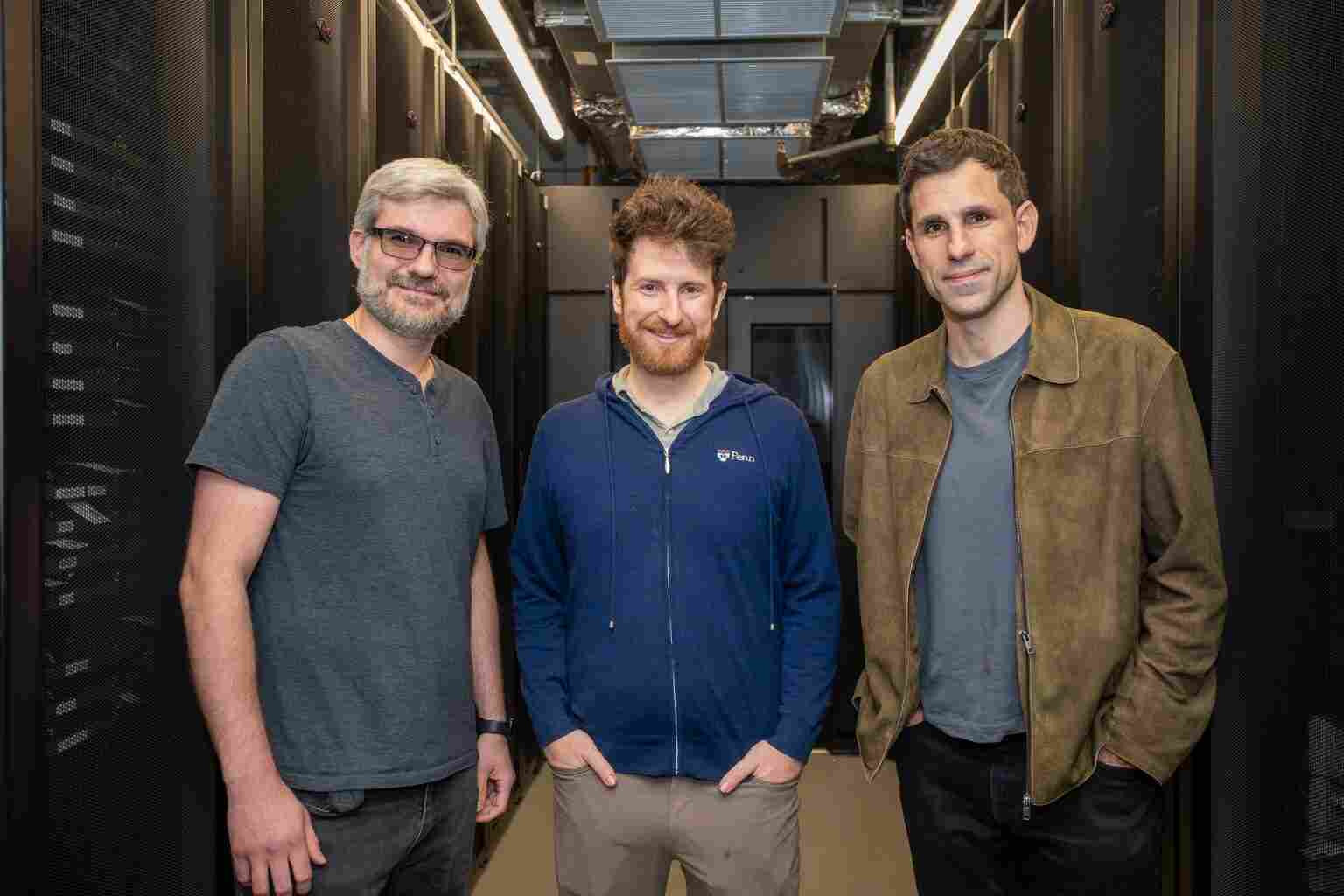 The researchers pose in the server room the Pennovation Center. From left: Marcelo Torres, Jacob R. Gardner and César de la Fuente. (Credit: Sylvia Zhang)