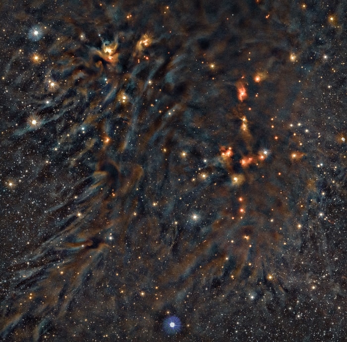 Deep near-infrared color composite image of the L1688 cloud in the Ophiuchus star-forming complex from the VISIONS European Southern Observatory public survey, where blue, green and red are mapped to the NIR bands J (1.2 μm), H (1.6 μm) and KS (2.2 μm), respectively.  CREDIT João Alves/ESO VISIONS