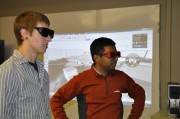 Balakrishnan and student view the iLab screen with special active shutter glasses enhance the 3-D experience.