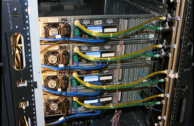 Back of server rack shows coolant flowing through the tubes into the server and carrying the heat out like a circulatory system.