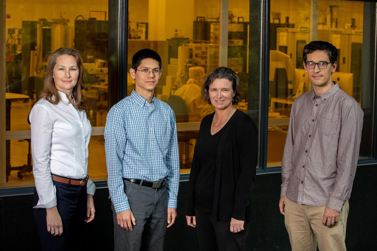 CAPTION GTRI researchers Brooke Beckert, Nicholas Guise, Alexa Harter and Adam Meier are shown outside the cleanroom of the Institute for Electronics and Nanotechnology at the Georgia Institute of Technology. Device fabrication for the DNA data storage project will be done in the facility behind them.  CREDIT Branden Camp, Georgia Tech