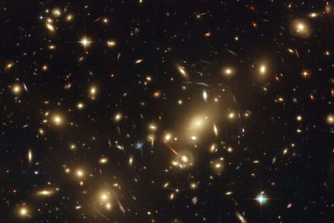 Image of Abell 2218, a dense galactic cluster located approximately 2 billion light years from Earth. Courtesy of NASA/ESA/Johan Richard.