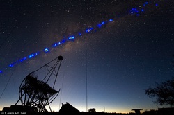 Photo showing the gamma-ray sky over Namibia, as measured by the four H.E.S.S. telescopes during the last years, superimposed onto an optical image, with one of the small H.E.S.S. telescopes in the foreground (Credit: H.E.S.S. Collaboration, Fabio Acero and Henning Gast)