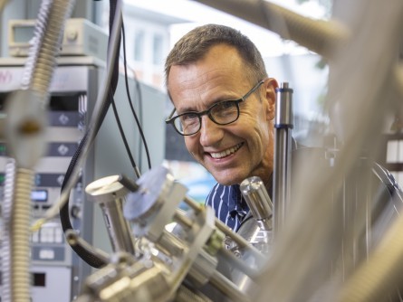 Gian Vaitl / Empa Roman Fasel, head of Empa's nanotech@surfaces laboratory, standing behind a scanning tunneling microscope in his lab.