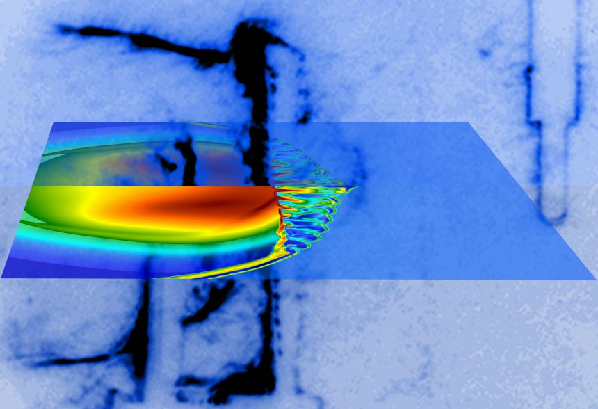 Laser beams illuminate a small carbon rod and launch an asymmetric shock inside a chamber filled with argon gas. A grid is placed in the shock's path, 1 centimetre from the target, resulting in turbulent flow. The shock and the turbulent flow is captured with the Schlieren imaging technique (blue-black hues) at 300 billionth of a second after the laser shot. The electron density predicted by computer simulations (blue-red hues) is superimposed.