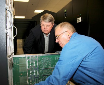 Buddy Bland, left, project director for an upgrade to Jaguar, America’s fastest supercomputer, looks on as Gary Eddy and other Cray personnel begin the process Monday at Oak Ridge National Laboratory. The upgrade will make the machine up to eight times faster by the end of 2012 due to the latest AMD Opteron central processing units and advanced graphics processing units from NVIDIA. Photo credit: Curtis Boles.