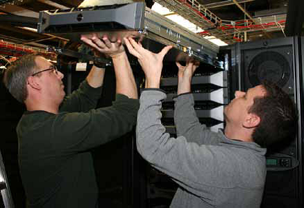  Endre Doeringsfeld and Paul Czerniak install a component. Photo credit: Mark Hobso